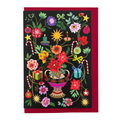 Painted Garden Christmas card by PAVILION with colourful flowers, candy canes, candles, baubles and wrapped gifts on a dark ground
