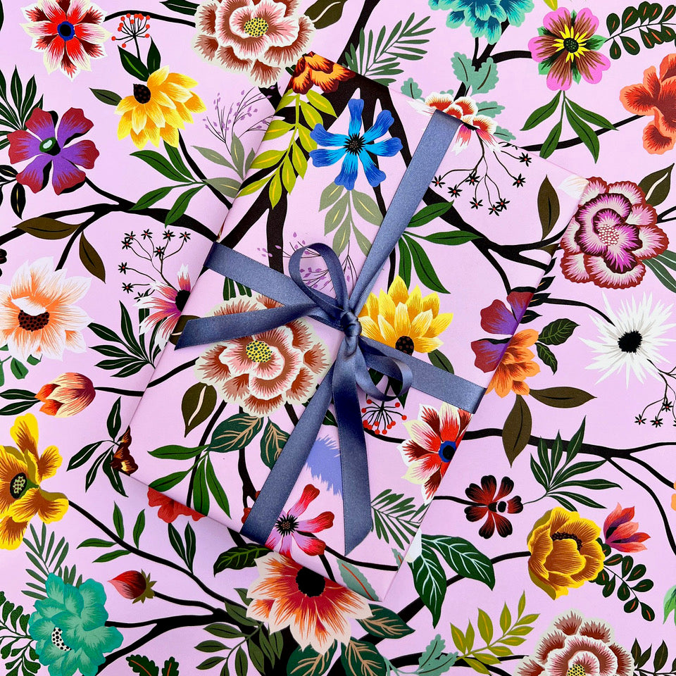 Painted Garden floral wrapping paper with wrapped gift and blue ribbon