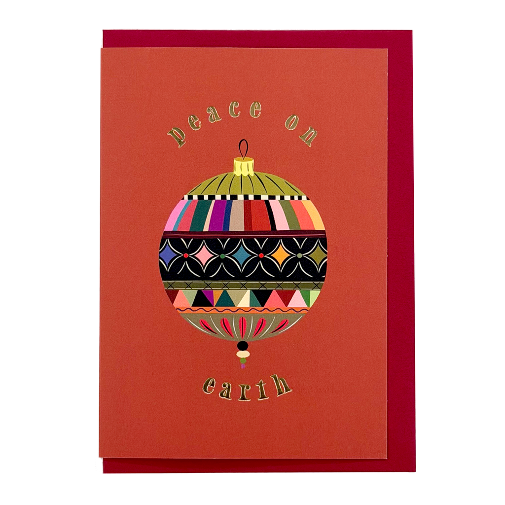 Peace Bauble Christmas card by PAVILION with patterned bauble illustration, gold foil lettering and red envelope
