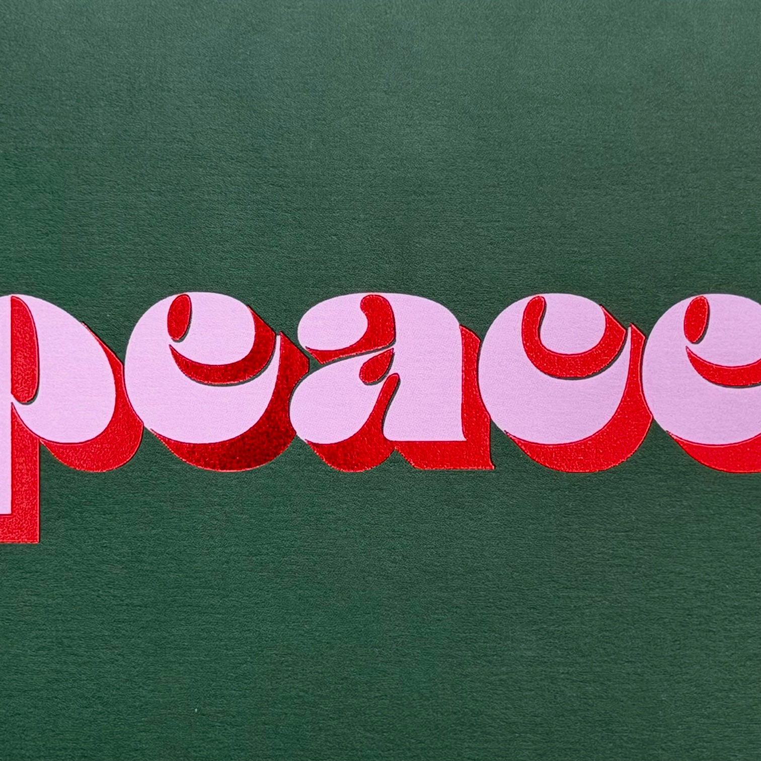 Close-up of the red foil typography on the Peace Christmas card