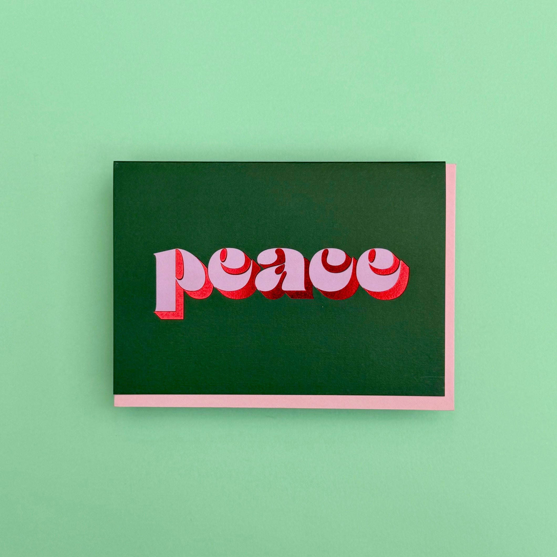 Peace Christmas card displayed against a green background