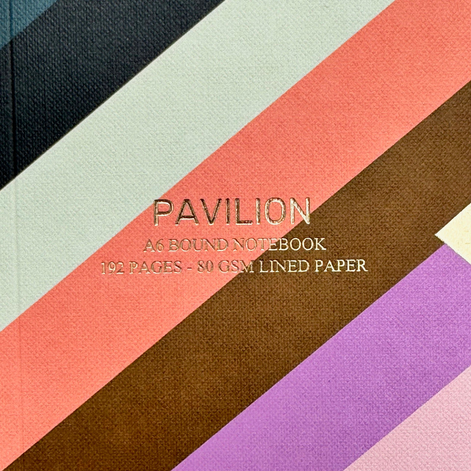 Close-up of Radar A6 notebook cover with gold foil lettering and colourful diagonal stripes