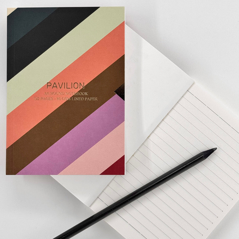 Radar A6 notebook with colourful diagonal striped cover, lined pages and black pencil