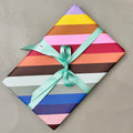 Wrapped gift in Radar wrapping paper with mint green ribbon
