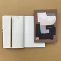 Rollright premium notebook shown open with mixed page layouts and abstract cover design