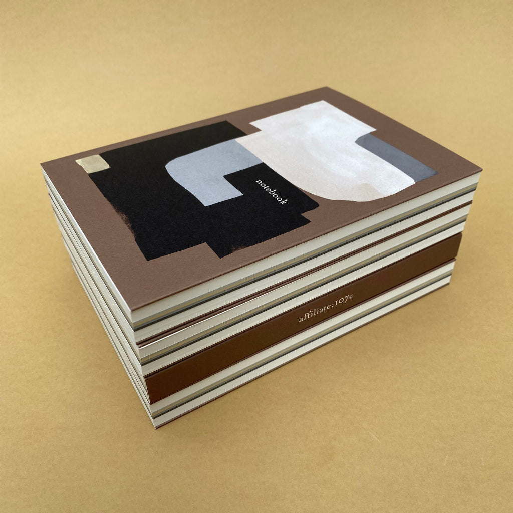 Stack of Rollright premium notebooks showing extended gate-fold covers and bound pages