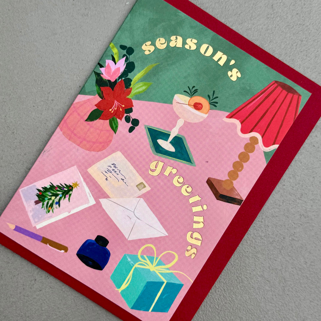 Angled view of Season's Greetings card by PAVILION with red envelope
