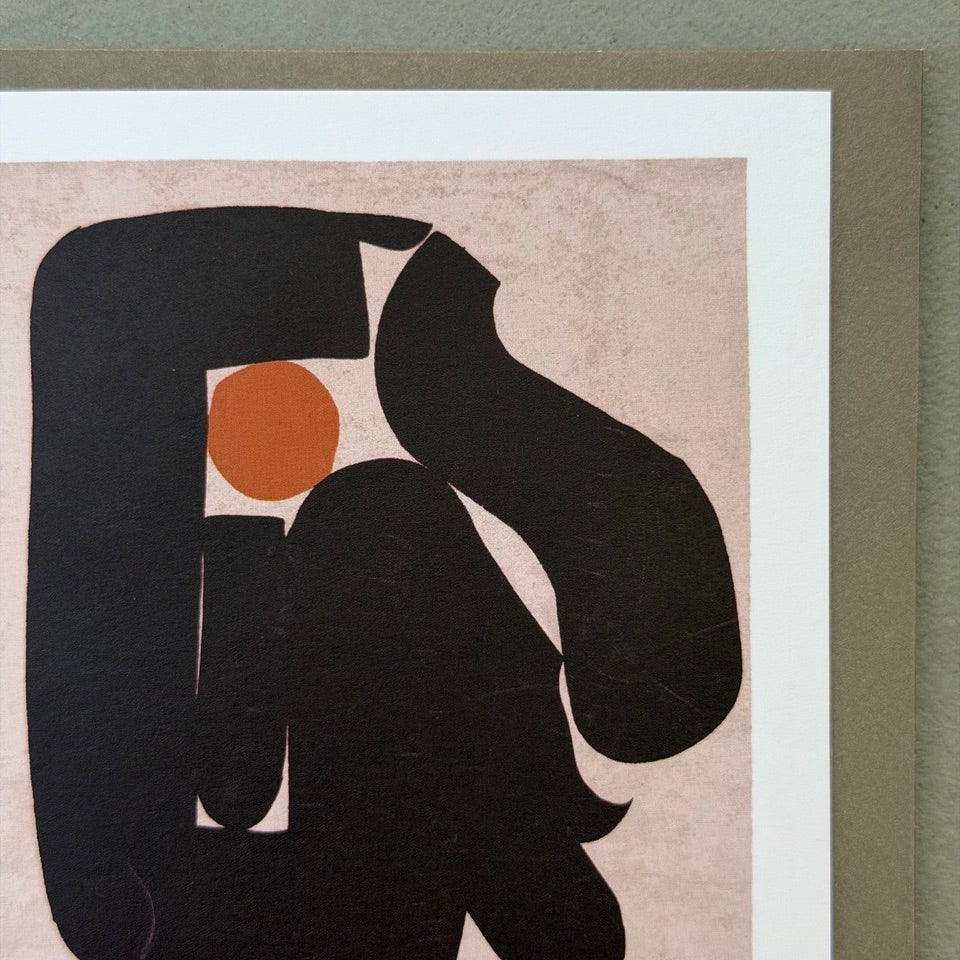 Close-up of the abstract black shapes and ochre circle on the So Proud of You greeting card.
