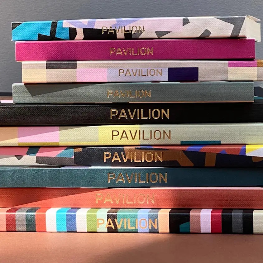 Stack of colourful PAVILION notebooks with gold foil spine details