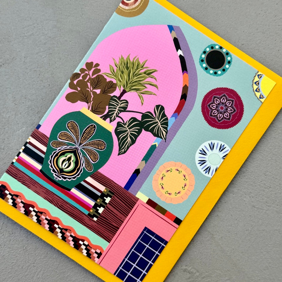Angled view of the Styled Interior greeting card on a mustard envelope.