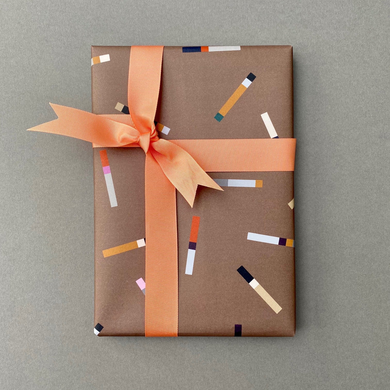 Wrapped gift in Tab wrapping paper with peach grosgrain ribbon