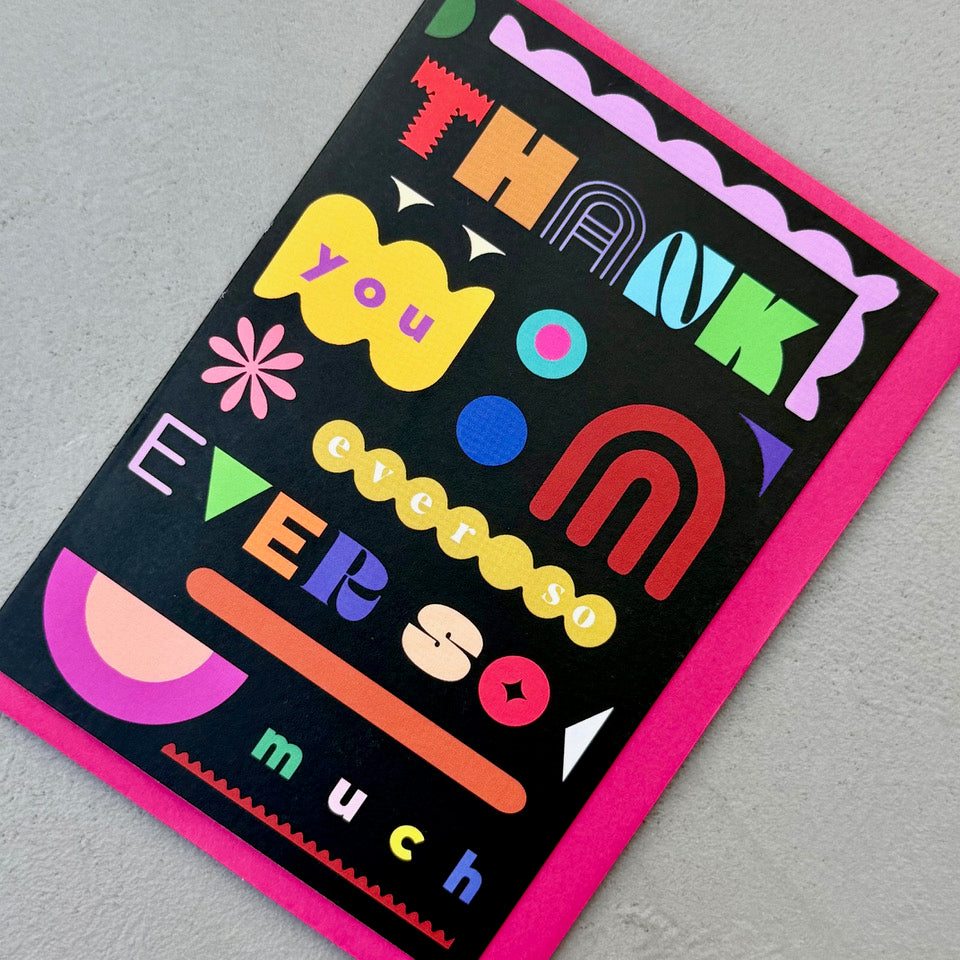 Angled view of the Thank You Ever So Much greeting card on a bright pink envelope.
