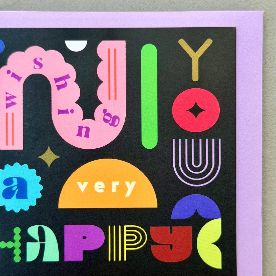 Close-up of the colourful typography and geometric shapes on the Wishing You A Very Happy Birthday greeting card.