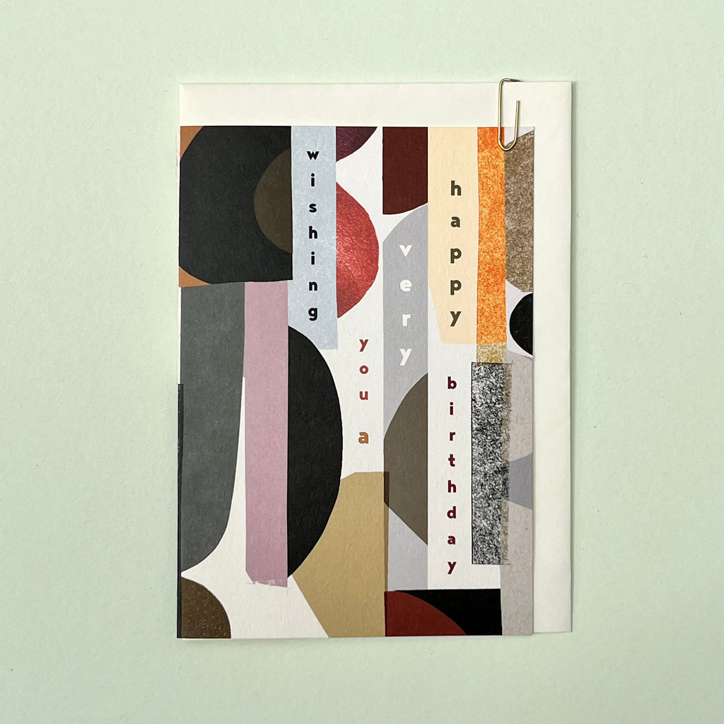 Abstract birthday card with cream envelope on a pale green background