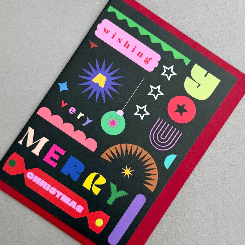 Angled view of Wishing You A Very Merry Christmas card by PAVILION with red envelope