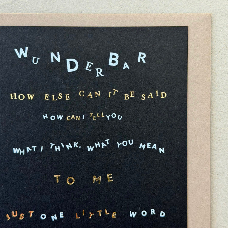 Close-up of the Wunderbar Typography greeting card highlighting the expressive typography, metallic gold foil accents and modern black design.