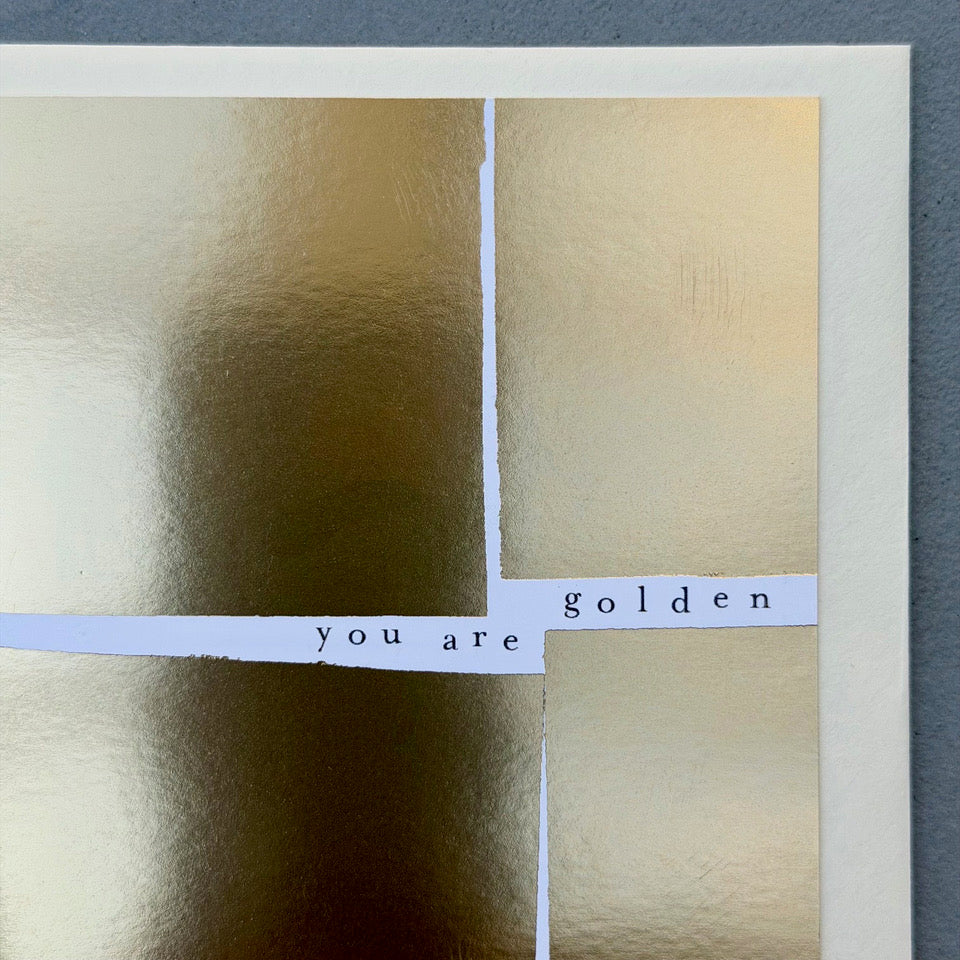 Close-up of the You Are Golden card highlighting the reflective gold foil finish, minimalist typography and contemporary graphic layout.
