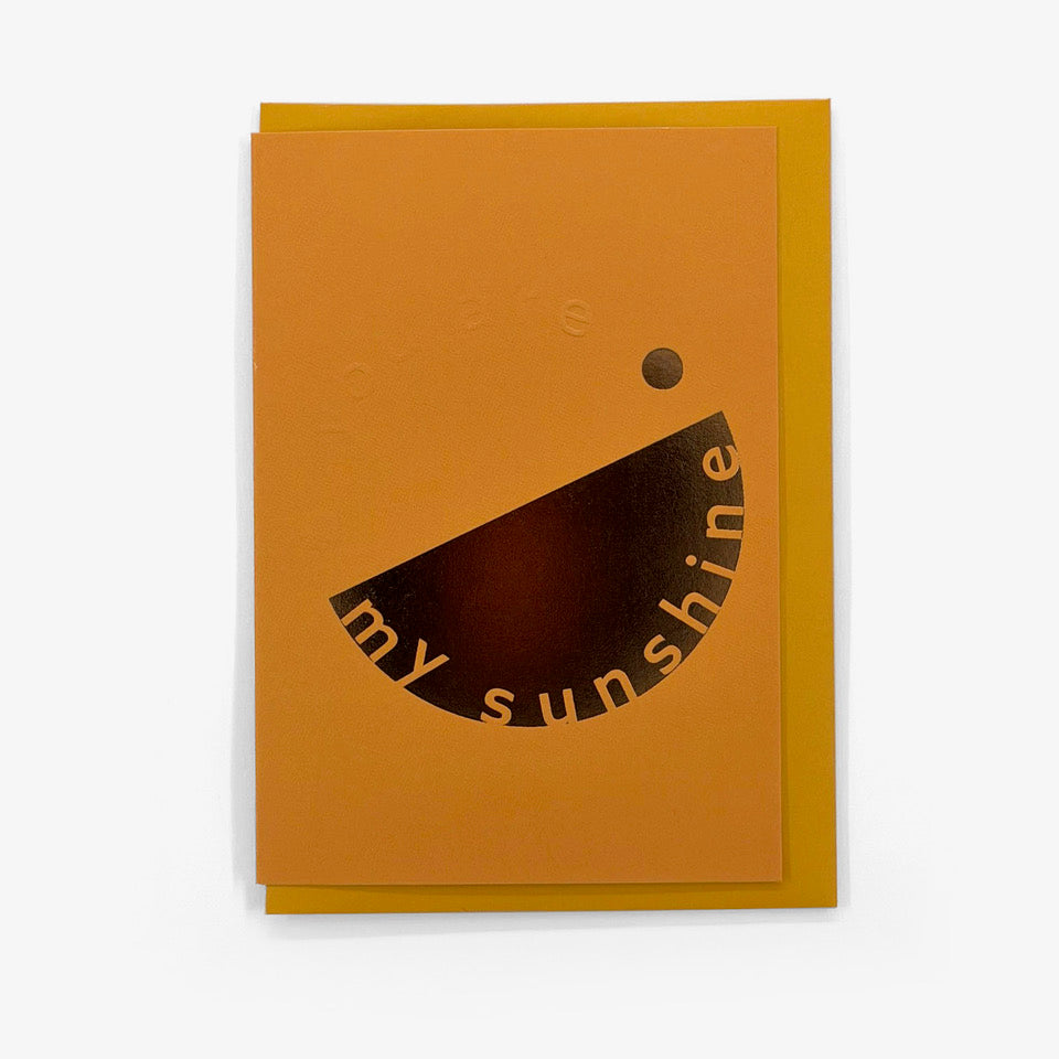 Orange You’re My Sunshine card with embossed lettering and gold foil graphic, shown with a mustard yellow envelope.
