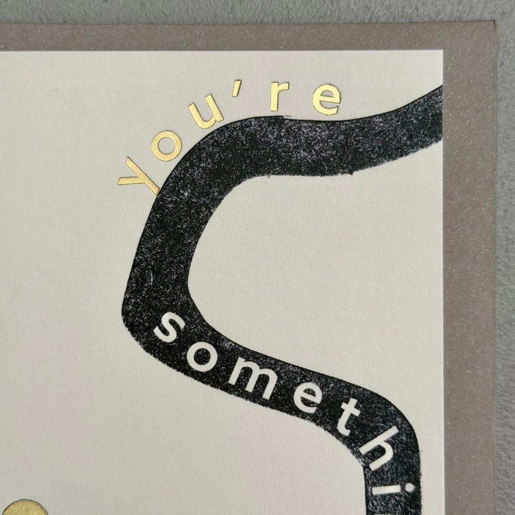 Close-up of You’re Something Special card showing black graphic typography and gold foil lettering