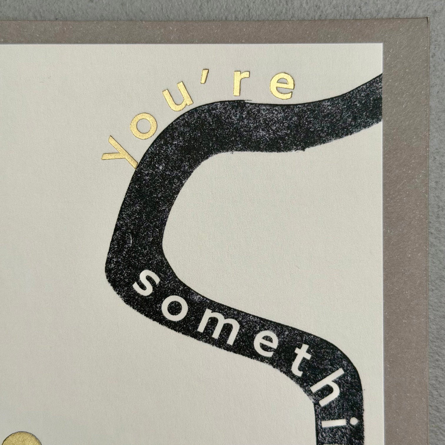 Close-up of You’re Something Special card showing black graphic typography and gold foil lettering