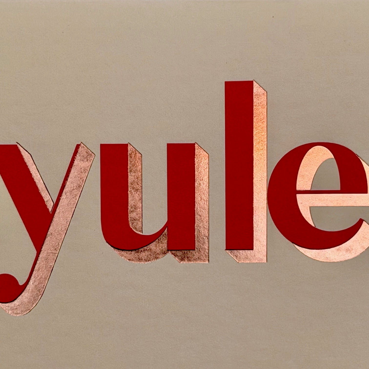 Close-up of the red foiled Yule lettering