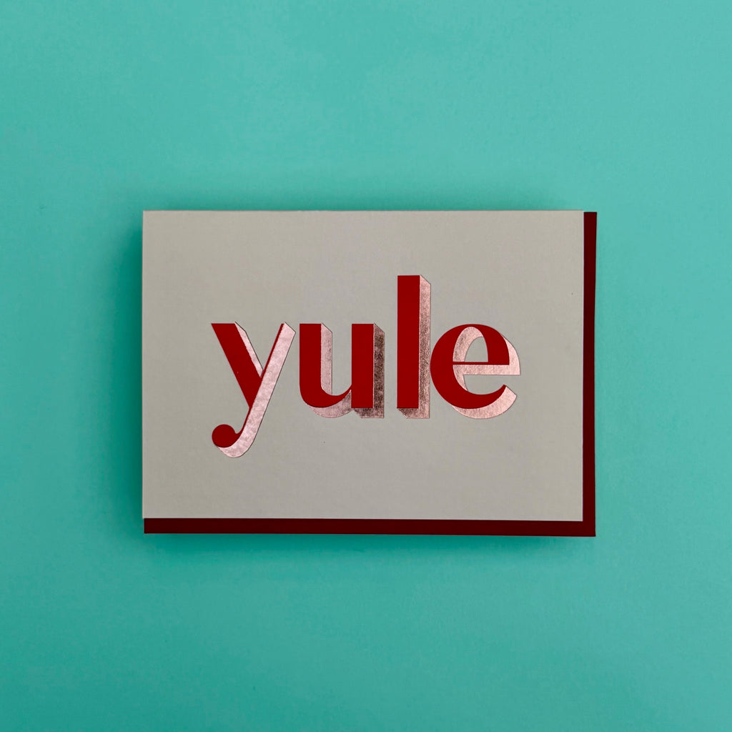 Yule Christmas card standing against a turquoise background