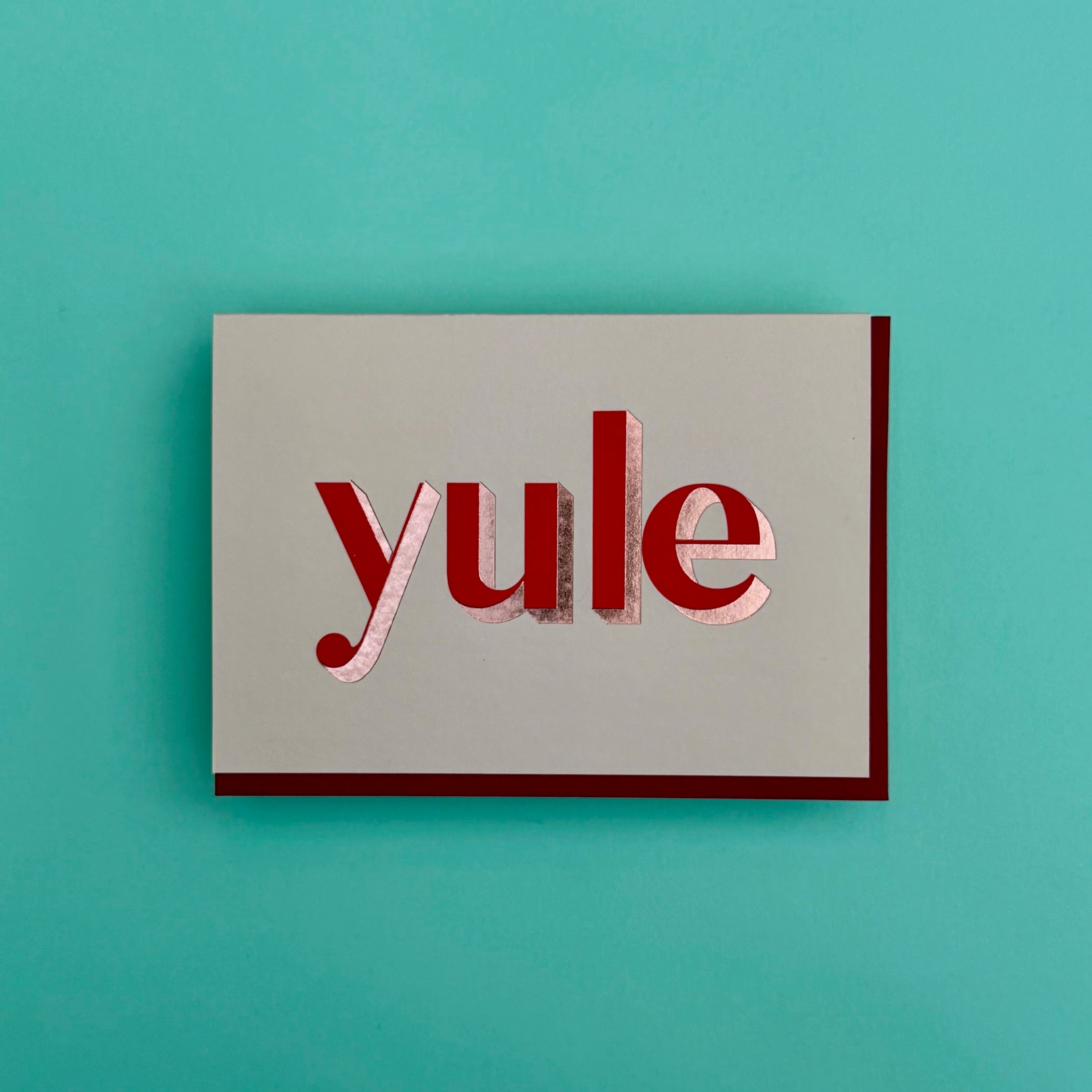 Yule Christmas card standing against a turquoise background