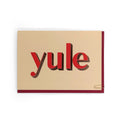 Yule Christmas card with red foiled typography on a cream background